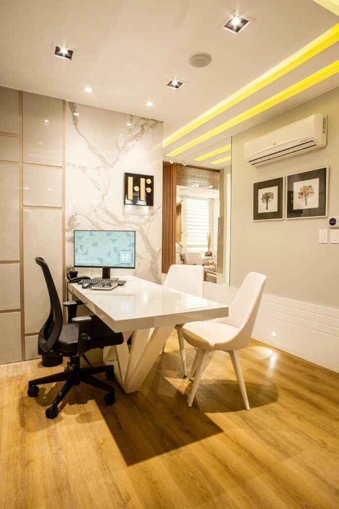 Elegant modern office interior featuring a sleek desk, chairs, and ambient lighting for a sophisticated environment.