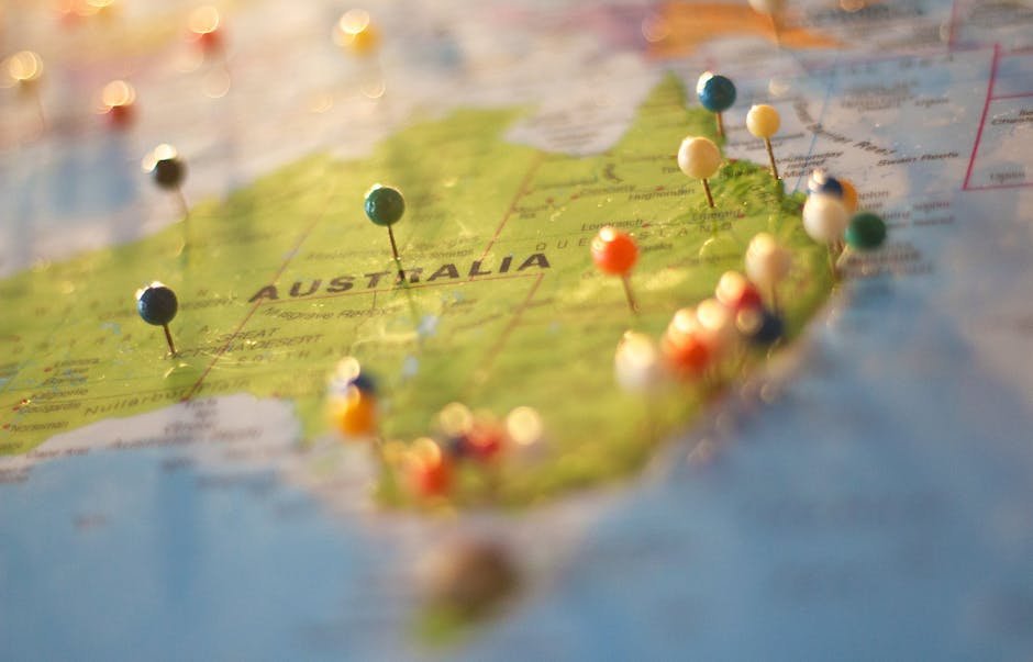 pexels-photo-68704-68704 Close-up of a map of Australia with colorful pins marking various cities and destinations.